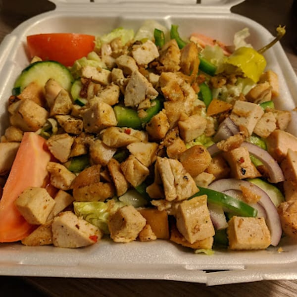 Goodfellas Pizza and Wings' chicken salad with lettuce, tomatoes, cucumbers, onions, and peppers.